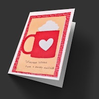 a greeting card with a heart and a cup of coffee