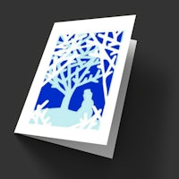 a card with a silhouette of a woman in a tree