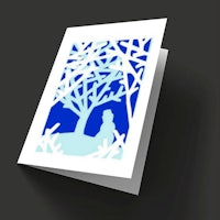 a card with a silhouette of a woman in a tree