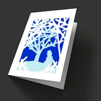 a card with a silhouette of a woman in a tree